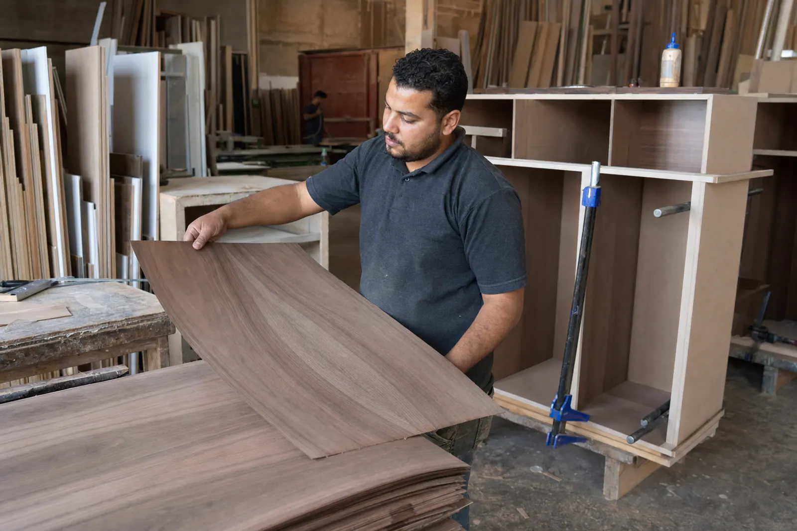 Joiner selecting veneer for custom cabinetry.